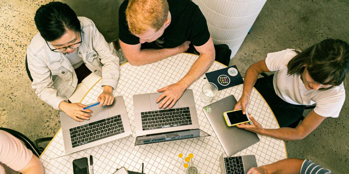 Top view of diverse team collaboratively working in a modern office setting.